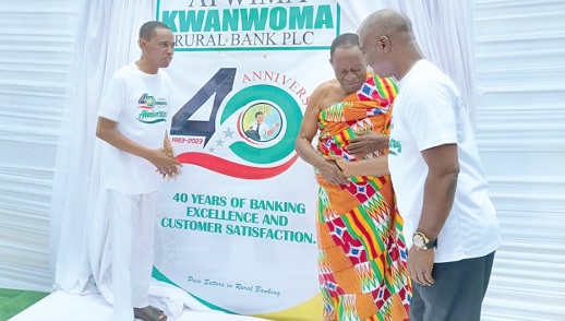 Samuel Bonsu Sekyere (right) in a chat with Nana Gyamfi after the launch of the anniversary logo. On the left is Rev. Emmanuel J. O. Bonsu, Board chair of the bank