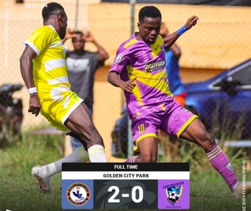 Medeama SC player in a tango with his Berekum Chelsea marker