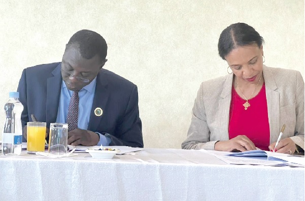 Dr Mohammed Amin Adam (left), Minister of Finance, and Eyerusalem Fasika, AfDB Ghana Country Manager, signing the agreement