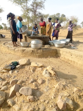 Some women gathered around a well in the community to fetch water