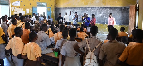 Buta explaining how the camera works to the children