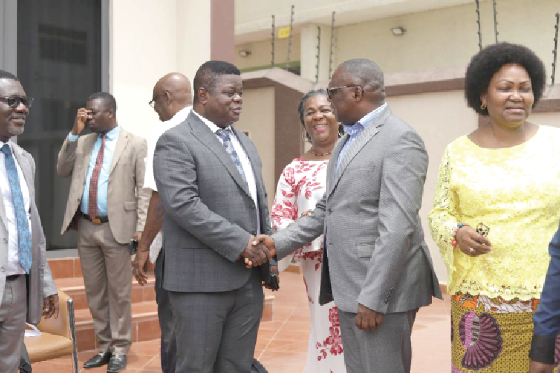 Professor Peter Quartey (left), Director, ISSER, interacting with Clement Osei-Amoako (right), President, GNCC, after the dialogue series. With them are other participants