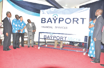 Mr Kwame Pianim (1st left), board chairman, Bayport, with some invited guests and management team of the company after unveiling the new logo in Accra. Picture: Samuel Tei Adano