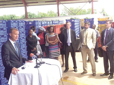  Mr Simmonds (left) announcing the £10-million fund during the visit to the Blue Skies Holding Limited.  Looking on are some of the delegates from the British High Commission and staff of the company. 