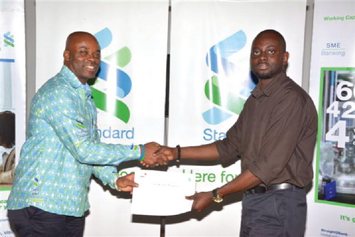 Nii Okai Nunoo (left), Regional Head of Sustainability for Africa, presenting a certificate to one of the participants