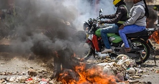 Nearby roads were blocked by piles of burning rubbish and littered with rocks