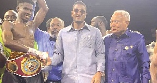 Referee Erasmus Owoo raises Faisal Abubakari’s hand in victory as Sharaf Mahama (centre), co-promoter,  congratulates him with a handshake