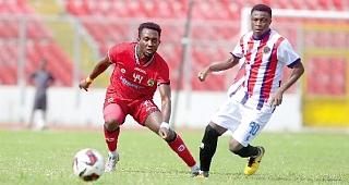 Kotoko’s Daniel Adjetey gains control of the ball ahead of Emmanuel Gyamfi of Legon Cities during their game yesterday. Picture: EMMANUEL BAAH